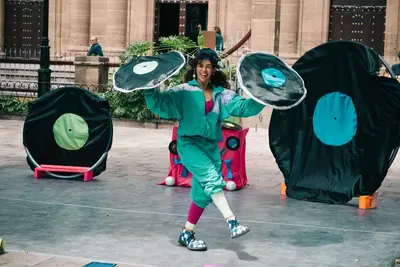 DJTami actúa con una rueda Cyr ante público familiar.